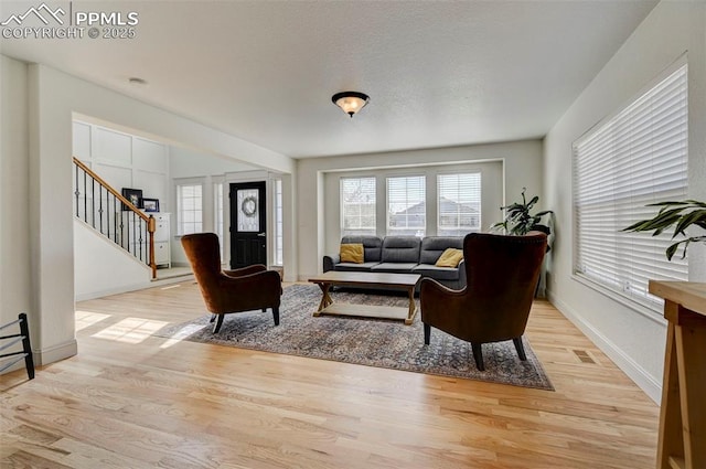 10368 Mount Evans Dr, Peyton, CO 80831 - living area with light wood finished floors, stairway, and baseboards