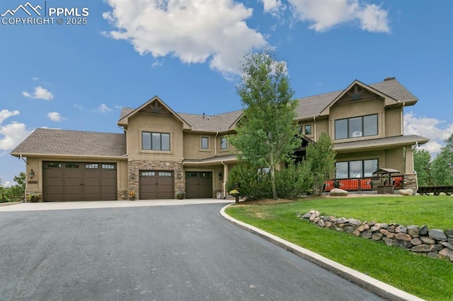 18320 Table Rock Rd, Colorado Springs, CO 80908 - view of front of home with stucco siding, driveway, stone siding, a front yard, and an attached garage