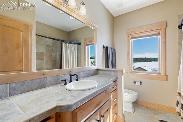 18320 Table Rock Rd, Colorado Springs, CO 80908 - full bathroom featuring vanity, toilet, healthy amount of natural light, and curtained shower