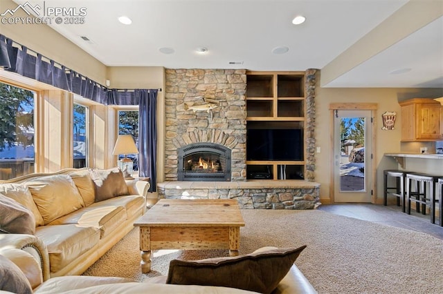 18320 Table Rock Rd, Colorado Springs, CO 80908 - tiled living room featuring healthy amount of natural light, a stone fireplace, recessed lighting, and carpet floors