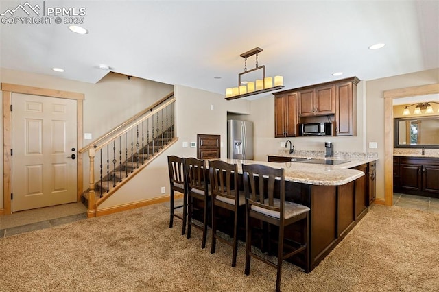 18320 Table Rock Rd, Colorado Springs, CO 80908 - kitchen featuring black microwave, stainless steel refrigerator with ice dispenser, light carpet, recessed lighting, and a breakfast bar area