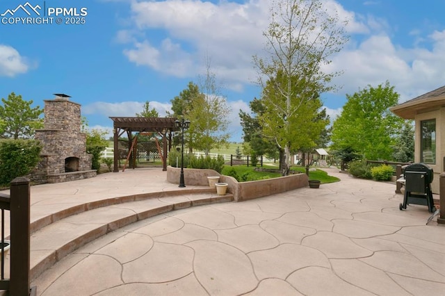 18320 Table Rock Rd, Colorado Springs, CO 80908 - view of patio / terrace with an outdoor stone fireplace, a pergola, and grilling area
