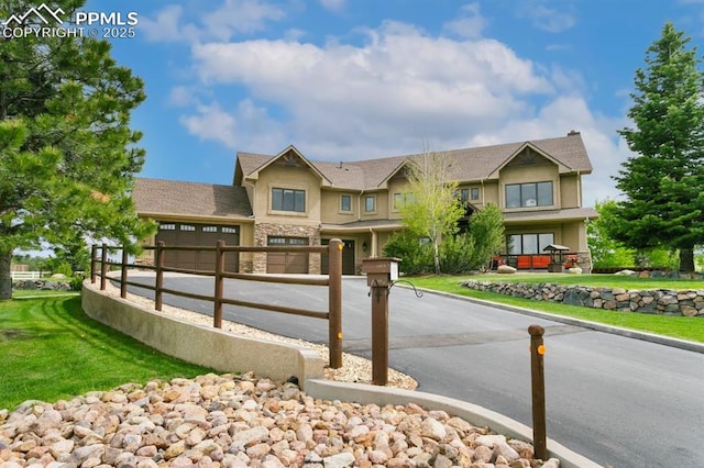 18320 Table Rock Rd, Colorado Springs, CO 80908 - view of front of home with stone siding, concrete driveway, stucco siding, and an attached garage