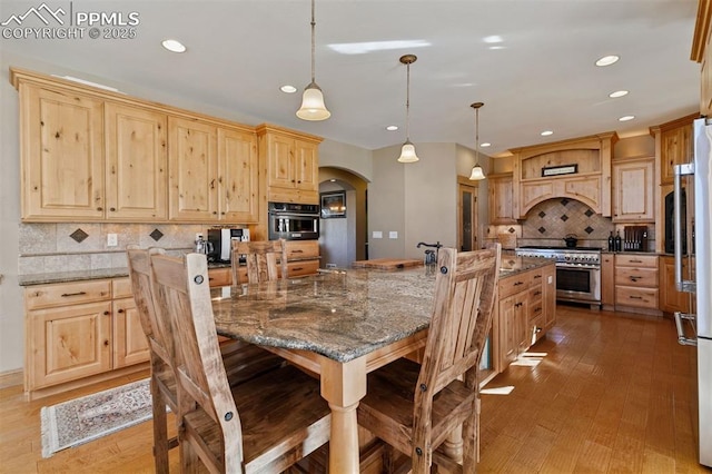 18320 Table Rock Rd, Colorado Springs, CO 80908 - dining room with arched walkways, recessed lighting, and wood-type flooring