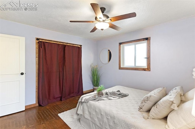 1004 Montrose Ave, Colorado Springs, CO 80905 - bedroom featuring wood-type flooring, a ceiling fan, baseboards, and a textured ceiling