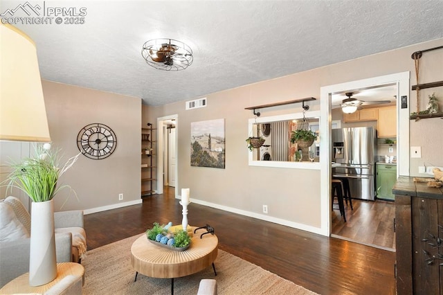 1004 Montrose Ave, Colorado Springs, CO 80905 - living room with wood finished floors, baseboards, a ceiling fan, a textured ceiling, and washer / clothes dryer