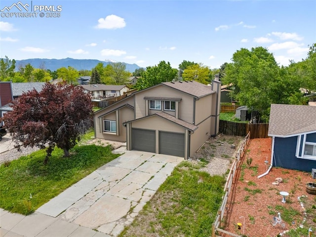 945 Bromefield Dr, Fountain, CO 80817 - view of front of property featuring driveway, a mountain view, a chimney, and a garage