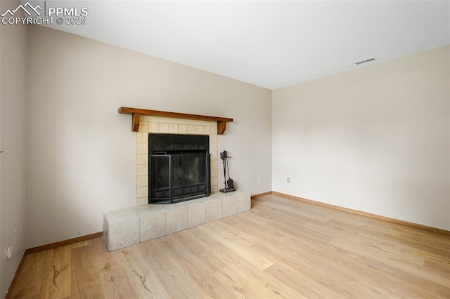 945 Bromefield Dr, Fountain, CO 80817 - unfurnished living room with wood finished floors, baseboards, and a fireplace