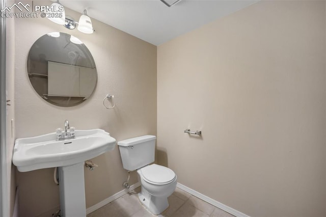 945 Bromefield Dr, Fountain, CO 80817 - half bathroom featuring toilet, tile patterned floors, and baseboards