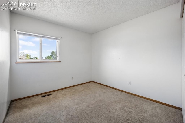 945 Bromefield Dr, Fountain, CO 80817 - spare room featuring carpet, baseboards, and a textured ceiling
