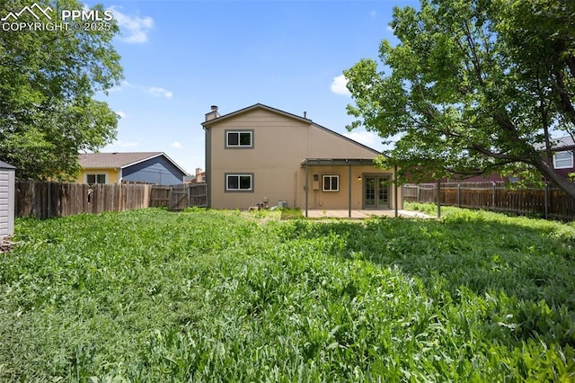 945 Bromefield Dr, Fountain, CO 80817 - rear view of house featuring french doors, a patio, and a fenced backyard