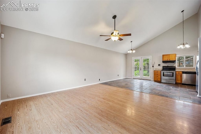 945 Bromefield Dr, Fountain, CO 80817 - unfurnished living room with a chandelier, ceiling fan, baseboards, high vaulted ceiling, and dark wood-style floors