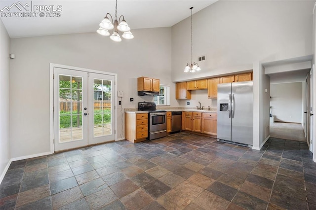 945 Bromefield Dr, Fountain, CO 80817 - kitchen with stainless steel appliances, high vaulted ceiling, a chandelier, light countertops, and stone tile flooring