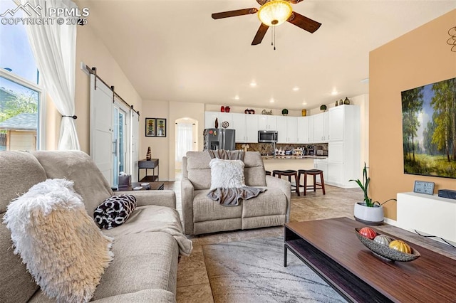 8004 Brittinger Way, Colorado Springs, CO 80951 - living area with arched walkways, a ceiling fan, and a barn door
