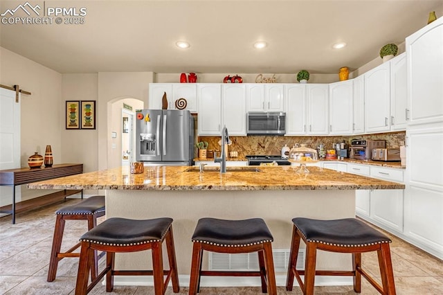 8004 Brittinger Way, Colorado Springs, CO 80951 - kitchen featuring stainless steel appliances, a sink, white cabinetry, tasteful backsplash, and recessed lighting