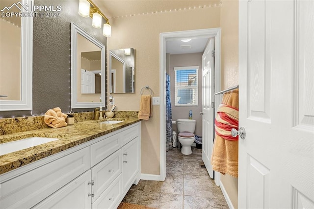 8004 Brittinger Way, Colorado Springs, CO 80951 - full bath with double vanity, toilet, and baseboards