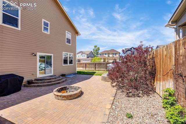 8004 Brittinger Way, Colorado Springs, CO 80951 - fenced backyard featuring a patio, a fire pit, and a residential view