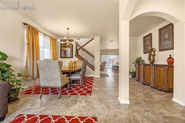 8004 Brittinger Way, Colorado Springs, CO 80951 - dining area with a chandelier, baseboards, stairs, arched walkways, and stone finish flooring