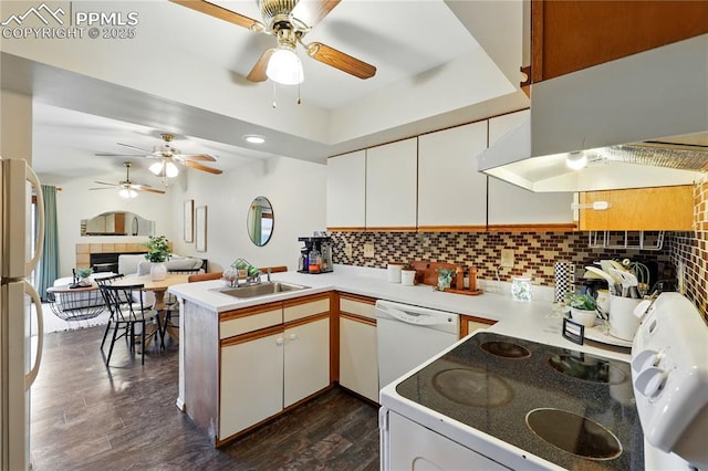 1225 Holland Park Blvd, Colorado Springs, CO 80907 - kitchen with a peninsula, a ceiling fan, tasteful backsplash, white appliances, and a sink
