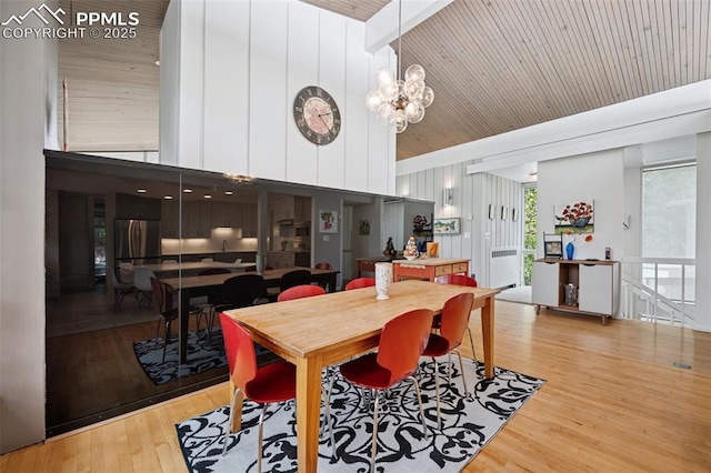 3 Heather Cir, Colorado Springs, CO 80906 - dining space featuring high vaulted ceiling, wood finished floors, and a chandelier
