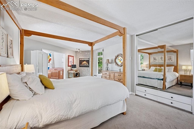 3 Heather Cir, Colorado Springs, CO 80906 - carpeted bedroom with a textured ceiling, a large fireplace, access to exterior, and lofted ceiling