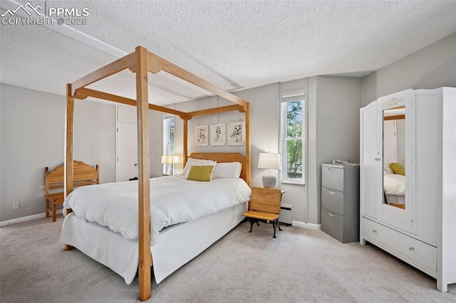 3 Heather Cir, Colorado Springs, CO 80906 - carpeted bedroom featuring a textured ceiling, a baseboard radiator, and baseboards