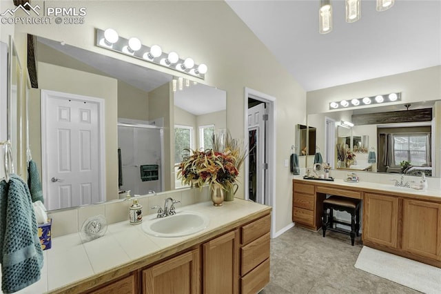 10641 Greenbelt Dr, Peyton, CO 80831 - full bathroom featuring lofted ceiling, a shower stall, vanity, and baseboards