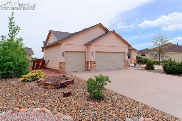 10641 Greenbelt Dr, Peyton, CO 80831 - view of front facade featuring an attached garage, stone siding, stucco siding, and concrete driveway