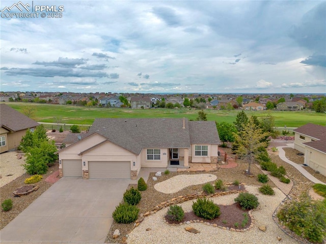 10641 Greenbelt Dr, Peyton, CO 80831 - ranch-style home featuring a residential view, an attached garage, concrete driveway, a shingled roof, and stucco siding