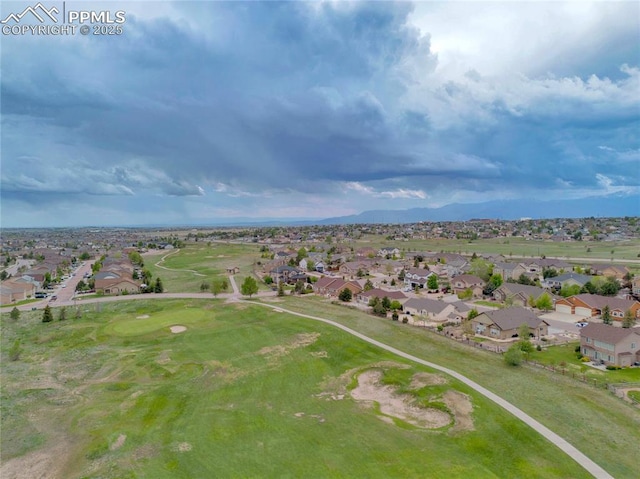 10641 Greenbelt Dr, Peyton, CO 80831 - aerial view of property's location featuring nearby suburban area, mountains, and a golf club