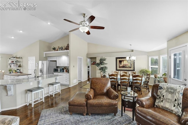 10641 Greenbelt Dr, Peyton, CO 80831 - living room with lofted ceiling, dark wood-type flooring, ceiling fan, a chandelier, and baseboards