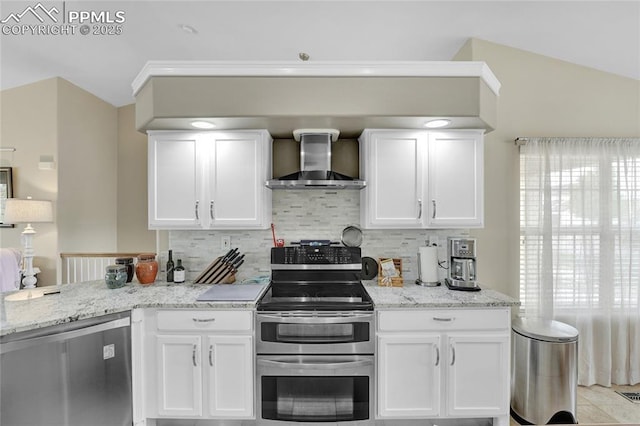 10641 Greenbelt Dr, Peyton, CO 80831 - kitchen featuring wall chimney exhaust hood, stainless steel appliances, backsplash, white cabinetry, and vaulted ceiling