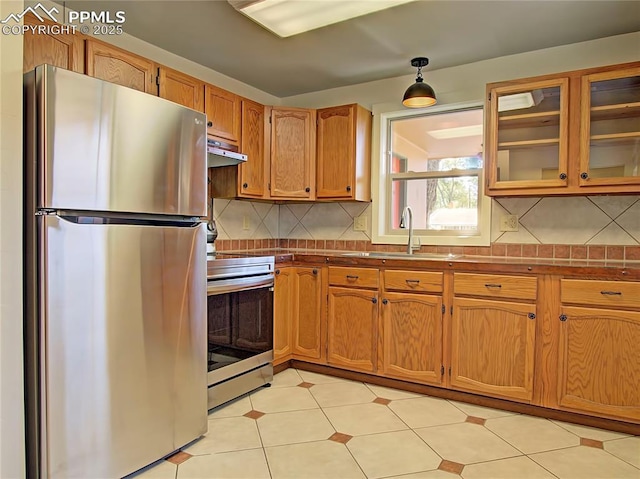 20 Swope Ave, Colorado Springs, CO 80909 - kitchen with appliances with stainless steel finishes, a sink, backsplash, dark countertops, and under cabinet range hood