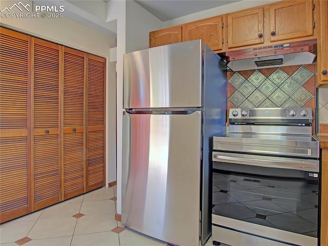 20 Swope Ave, Colorado Springs, CO 80909 - kitchen featuring freestanding refrigerator, under cabinet range hood, light tile patterned flooring, and backsplash