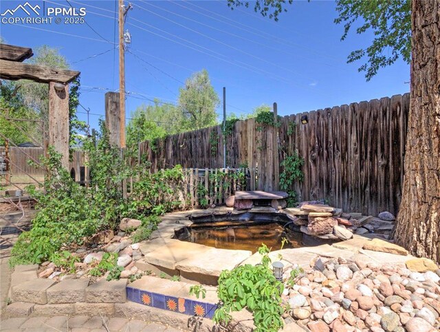 20 Swope Ave, Colorado Springs, CO 80909 - view of patio / terrace with a garden pond