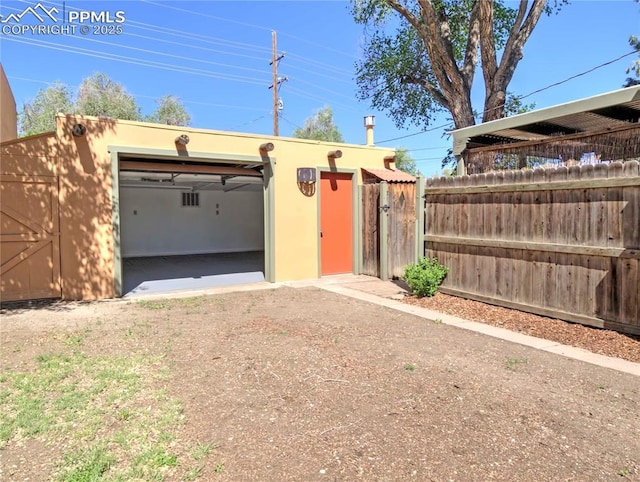 20 Swope Ave, Colorado Springs, CO 80909 - view of front of house with driveway, an outbuilding, stucco siding, and a garage