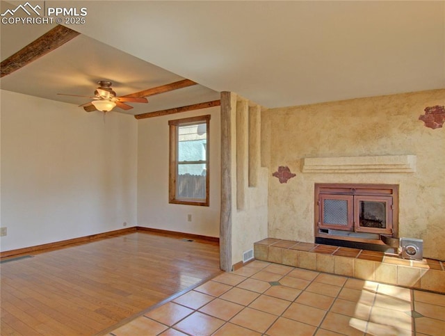 20 Swope Ave, Colorado Springs, CO 80909 - unfurnished living room with ceiling fan, baseboards, light tile patterned floors, and a tile fireplace