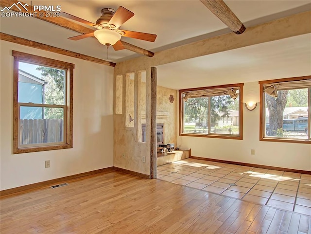 20 Swope Ave, Colorado Springs, CO 80909 - spare room featuring baseboards, plenty of natural light, light wood-style floors, and beamed ceiling