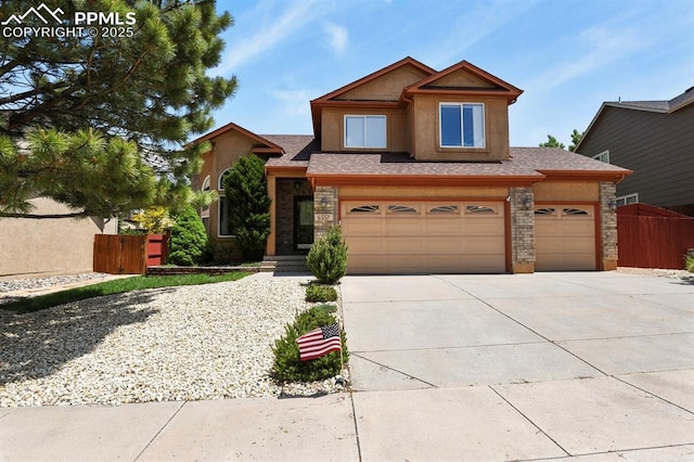 6557 Many Moon Dr, Colorado Springs, CO 80923 - view of front of house with concrete driveway, stucco siding, stone siding, and a garage