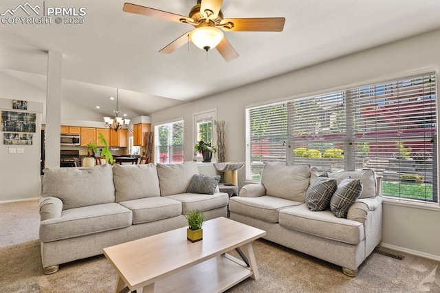 6557 Many Moon Dr, Colorado Springs, CO 80923 - living room with light carpet, baseboards, plenty of natural light, a chandelier, and vaulted ceiling