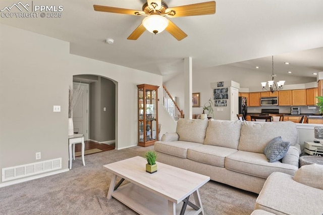 6557 Many Moon Dr, Colorado Springs, CO 80923 - living area featuring arched walkways, light colored carpet, a chandelier, recessed lighting, and stairway