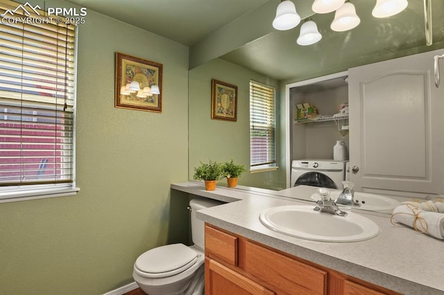 6557 Many Moon Dr, Colorado Springs, CO 80923 - bathroom featuring washer / clothes dryer, vanity, and toilet