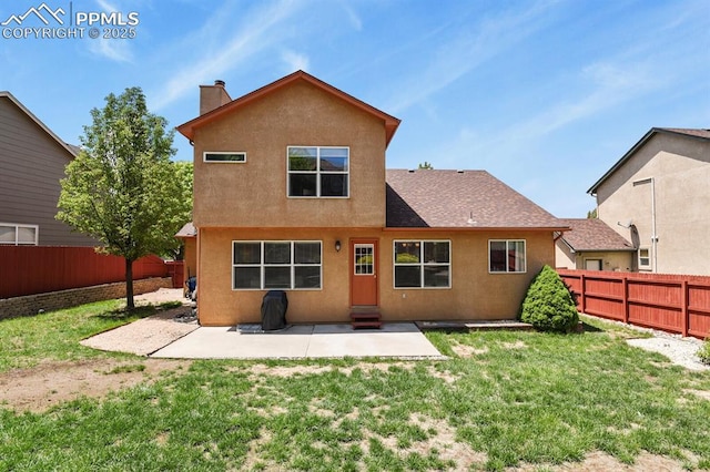 6557 Many Moon Dr, Colorado Springs, CO 80923 - back of house with a patio area, stucco siding, and a chimney