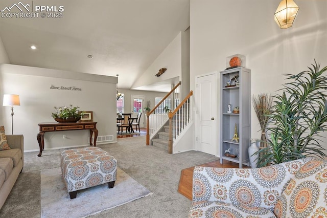 6557 Many Moon Dr, Colorado Springs, CO 80923 - living room with carpet floors, a high ceiling, stairs, recessed lighting, and baseboards