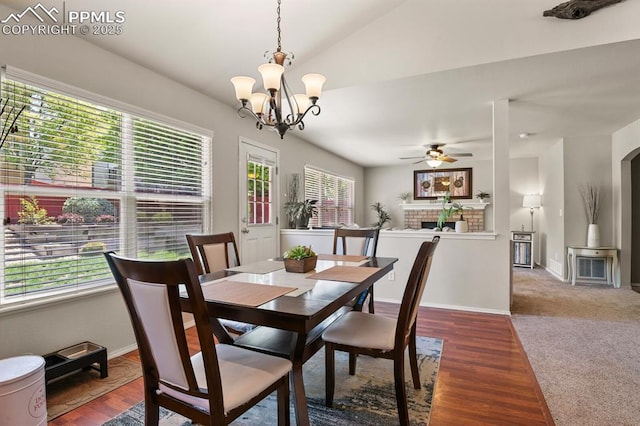 6557 Many Moon Dr, Colorado Springs, CO 80923 - dining room with a ceiling fan, vaulted ceiling, a chandelier, baseboards, and arched walkways