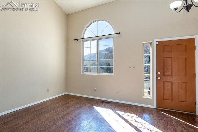 7435 Julynn Rd, Colorado Springs, CO 80919 - entryway with wood finished floors, a chandelier, and baseboards