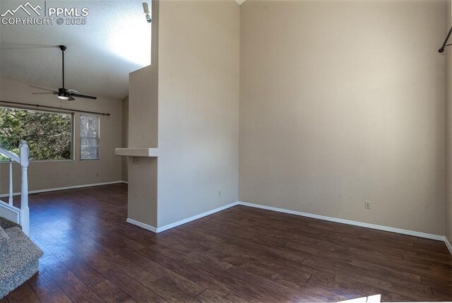 7435 Julynn Rd, Colorado Springs, CO 80919 - empty room with dark wood-style flooring, ceiling fan, baseboards, and vaulted ceiling