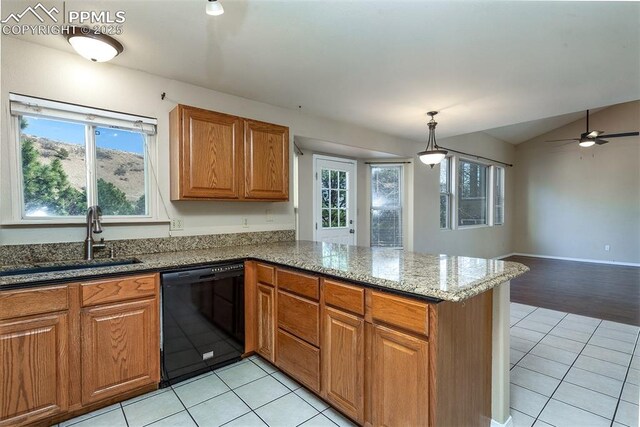 7435 Julynn Rd, Colorado Springs, CO 80919 - kitchen featuring black dishwasher, a sink, light tile patterned floors, a peninsula, and brown cabinets
