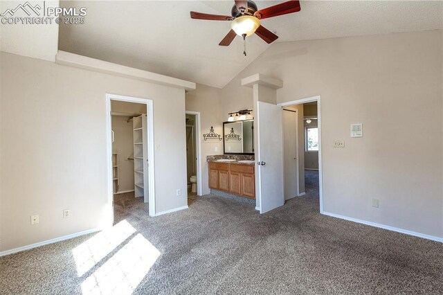 7435 Julynn Rd, Colorado Springs, CO 80919 - unfurnished bedroom with carpet floors, a spacious closet, baseboards, and lofted ceiling