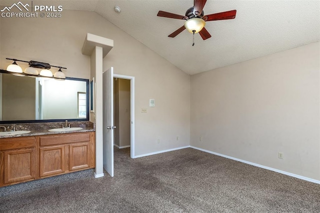7435 Julynn Rd, Colorado Springs, CO 80919 - unfurnished bedroom featuring a sink, lofted ceiling, dark colored carpet, baseboards, and ceiling fan